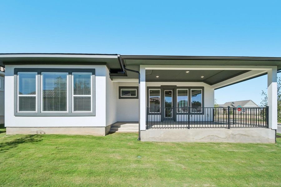 Back of house featuring a patio area and a lawn