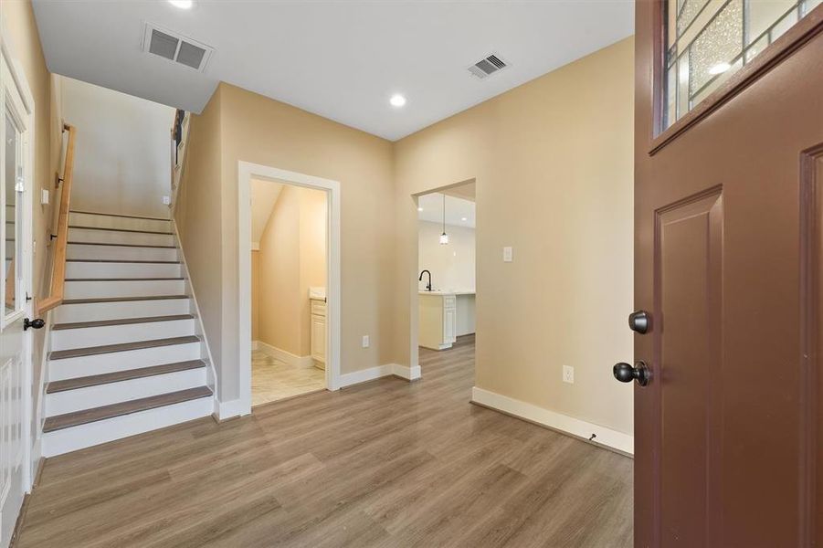 As you step through the front door, you're greeted by a bright, welcoming foyer