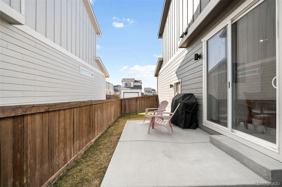 Fenced and landscaped yard with a concrete patio