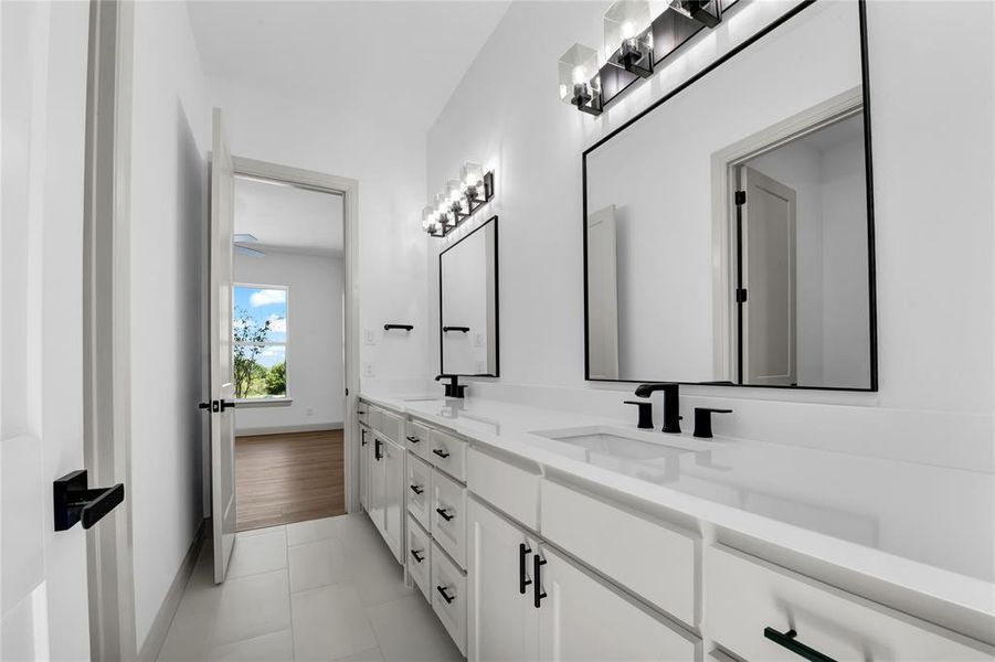 Bathroom with tile patterned flooring and vanity