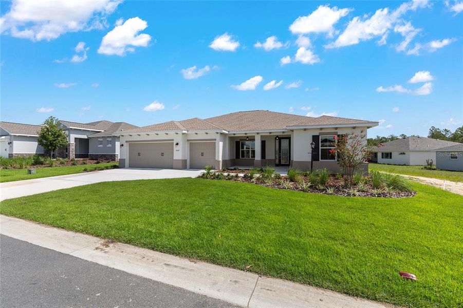 Front exterior of a new home in On Top of the World Communities, Ocala, FL, highlighting curb appeal (Image 19).