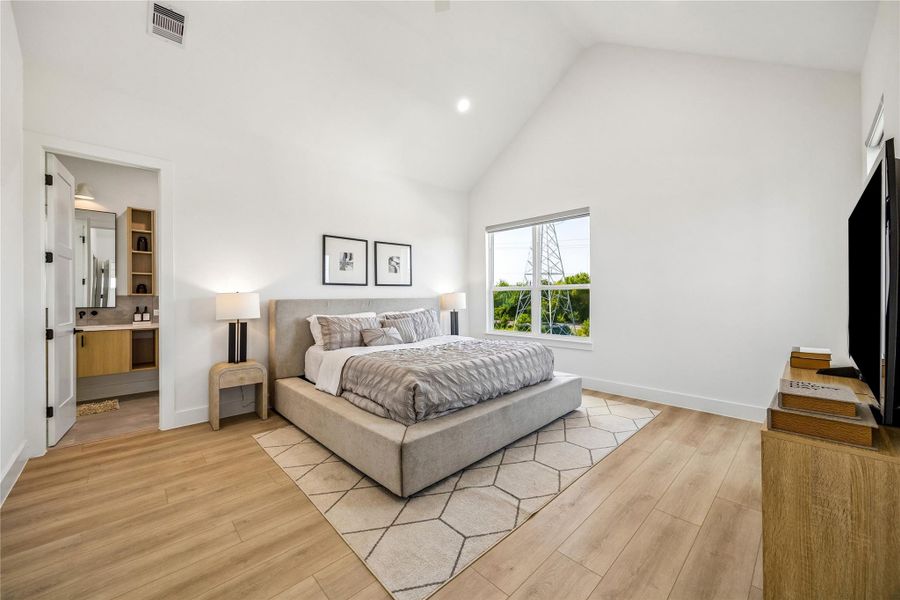 A vaulted ceiling elevates the spacious primary suite, creating a peaceful retreat filled with natural light.