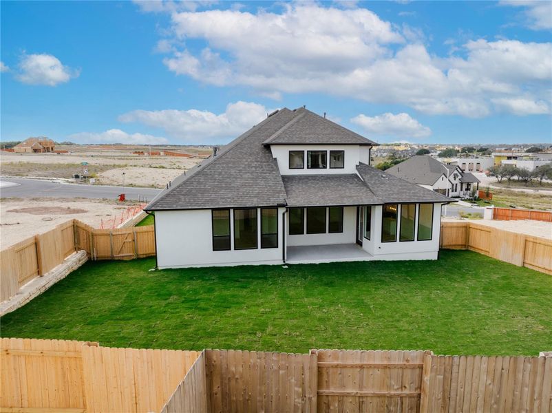 Back of property with roof with shingles, a patio, a fenced backyard, and stucco siding