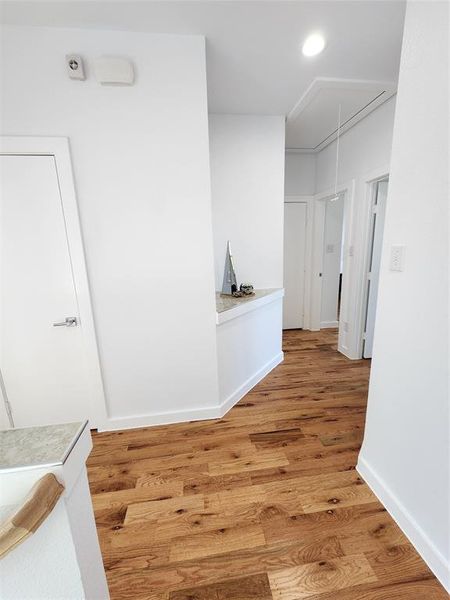 Hallway with wood-type flooring