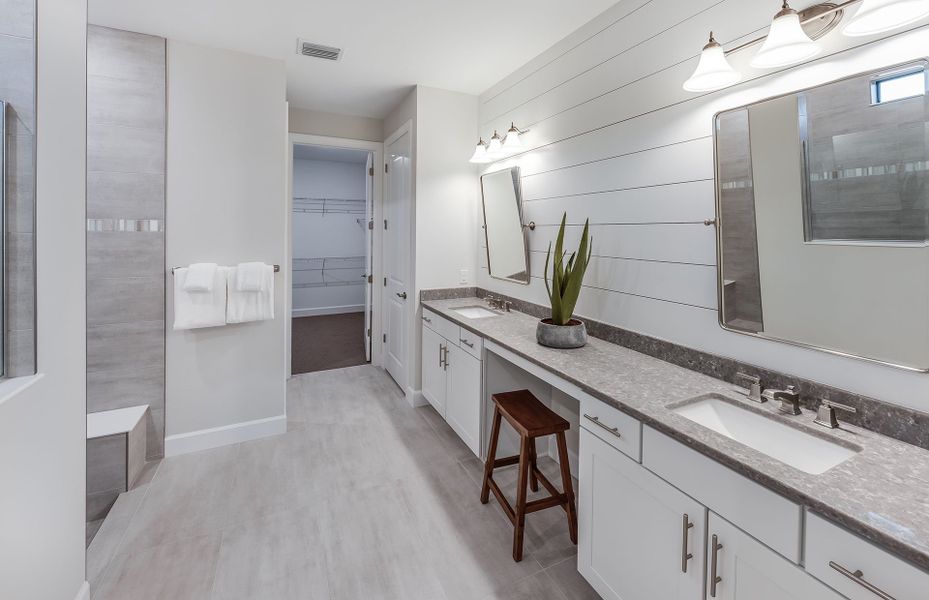 Owner's bathroom with dual sink vanity and walk-in shower