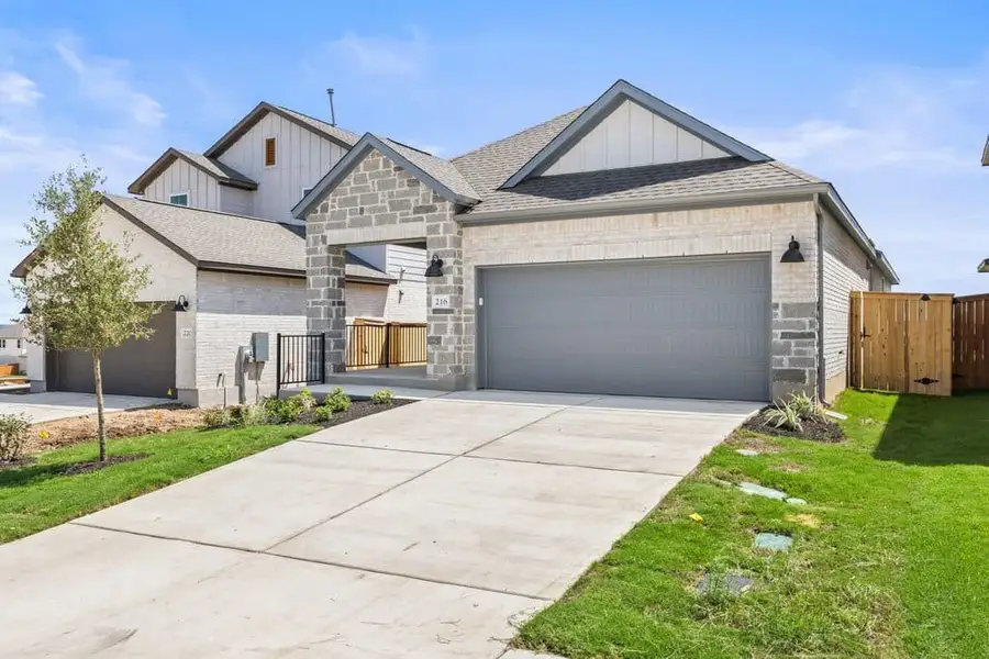 Front exterior of a new home in Lariat, Liberty Hill, TX, highlighting curb appeal (Image 2). Front exterior of a new home in Lariat, Liberty Hill, TX, highlighting curb appeal (Image 2).