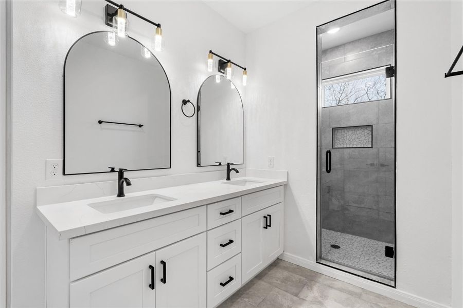 Luxurious primary bath featuring dual sinks with a spacious vanity, perfect for everyday convenience.