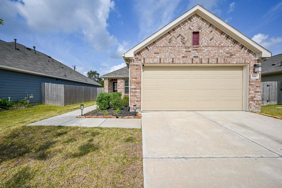 Front exterior of a new home in Mustang Crossing, Alvin, TX, highlighting curb appeal (Image 22).
