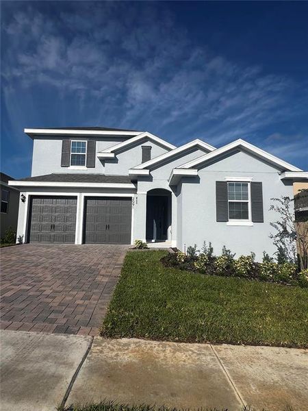 Front exterior of a new home in Hills of Minneola, Minneola, FL, highlighting curb appeal (Image 2).