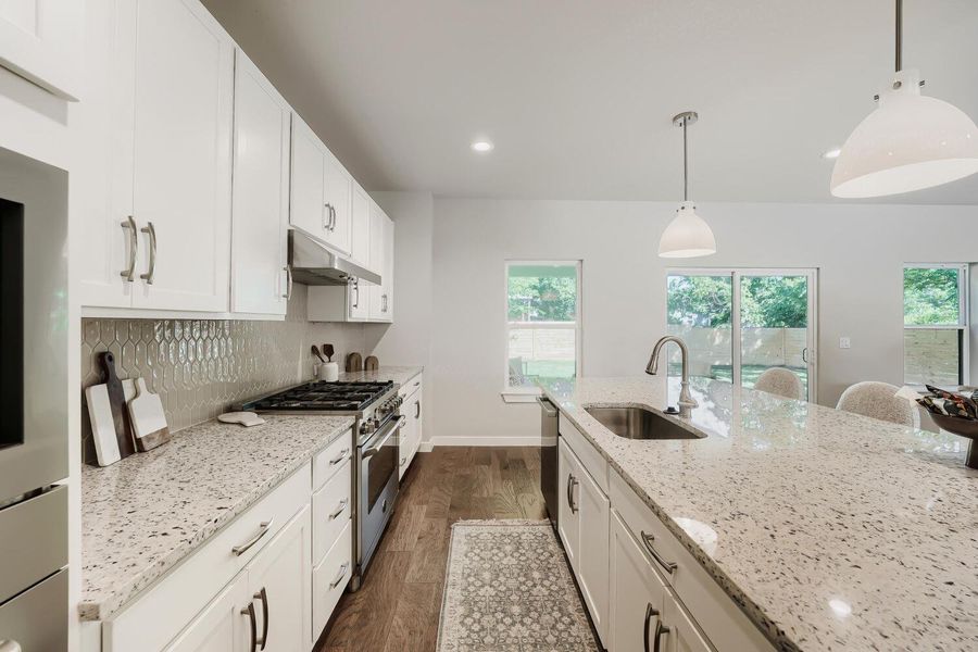 Prepare culinary delights in this well-appointed kitchen, featuring a spacious island and modern appliances. Prepare culinary delights in this well-appointed kitchen, featuring a spacious island and modern appliances.