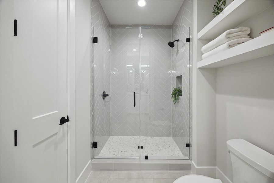 The Hollywood bath's shower space is separated from the vanity space and has a linen closet.