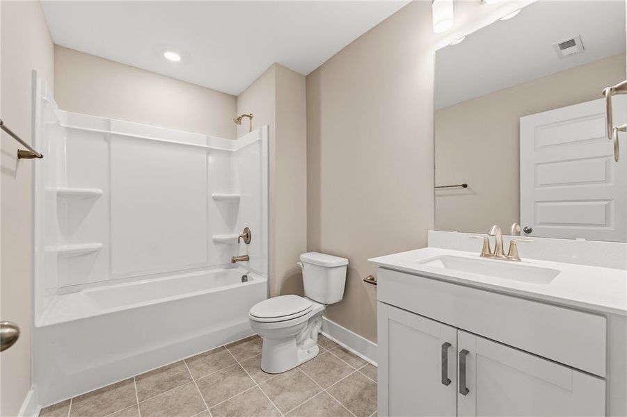 A well-appointed bathroom offers a clean vanity, b