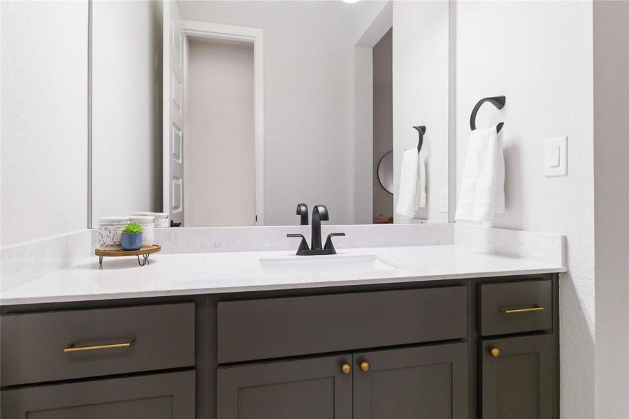 Bathroom with a textured wall and vanity Bathroom with a textured wall and vanity
