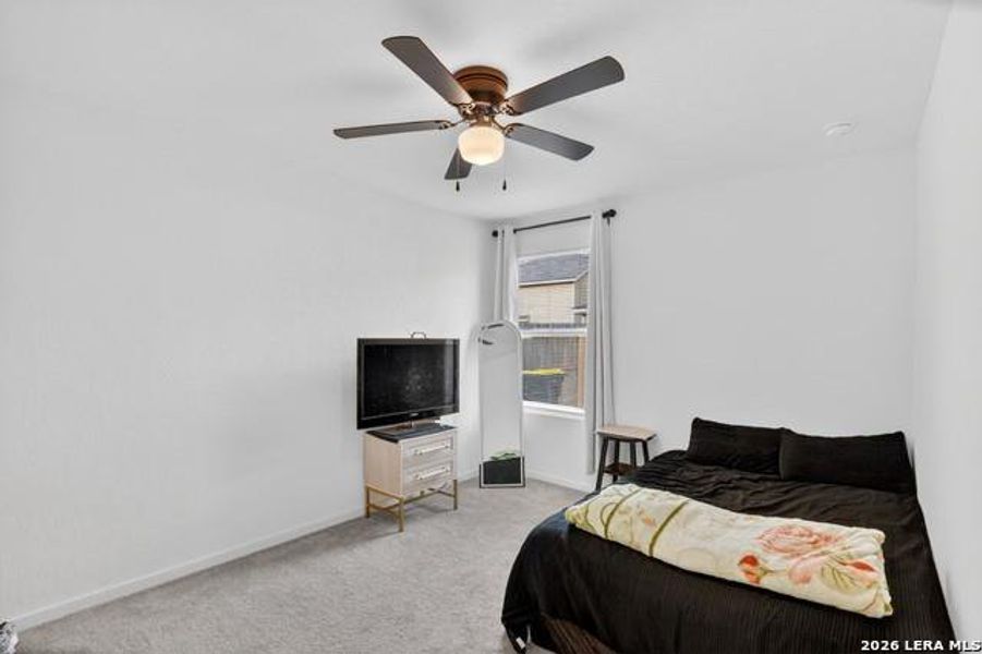 Well-lit room featuring a window and a practical ceiling fan for comfort. Well-lit room featuring a window and a practical ceiling fan for comfort.