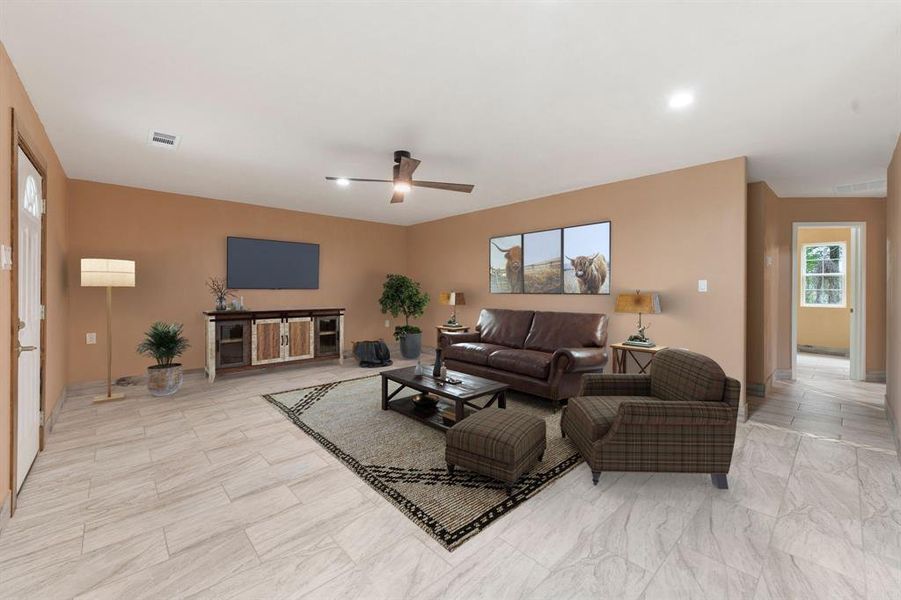 Living area with visible vents, ceiling fan, and recessed lighting Living area with visible vents, ceiling fan, and recessed lighting