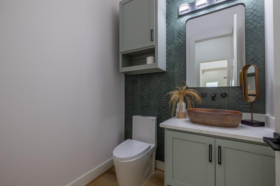 Stylish first-floor powder bath featuring modern cabinetry and contemporary fixtures.
