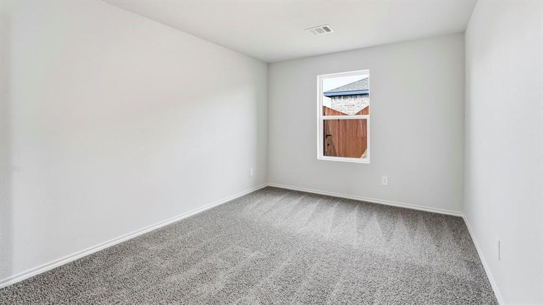 Empty room featuring light carpet and baseboards Empty room featuring light carpet and baseboards