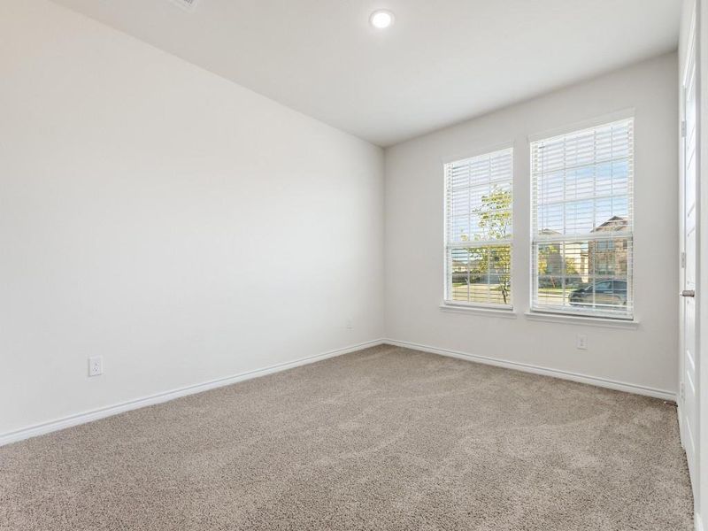 bed room with light carpet and recessed lighting