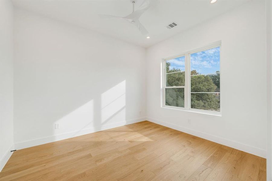 Unfurnished room with light wood-style floors, a ceiling fan, and recessed lighting Unfurnished room with light wood-style floors, a ceiling fan, and recessed lighting