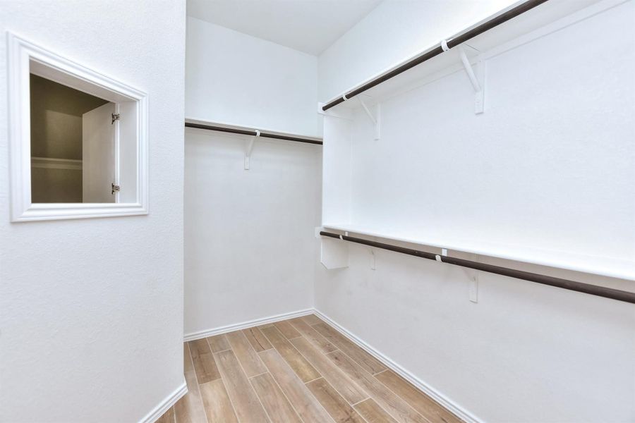 Walk in closet with wood tiled floor