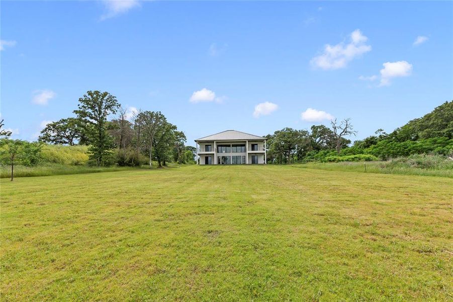 Expansive yard with plenty of space to add pool, outdoor kitchen, pickleball court, firepit etc.