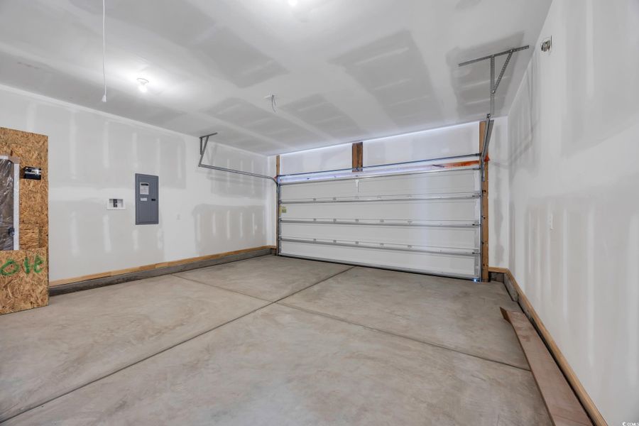 Laundry area with wood finished floors, washer hookup, and hookup for an electric dryer