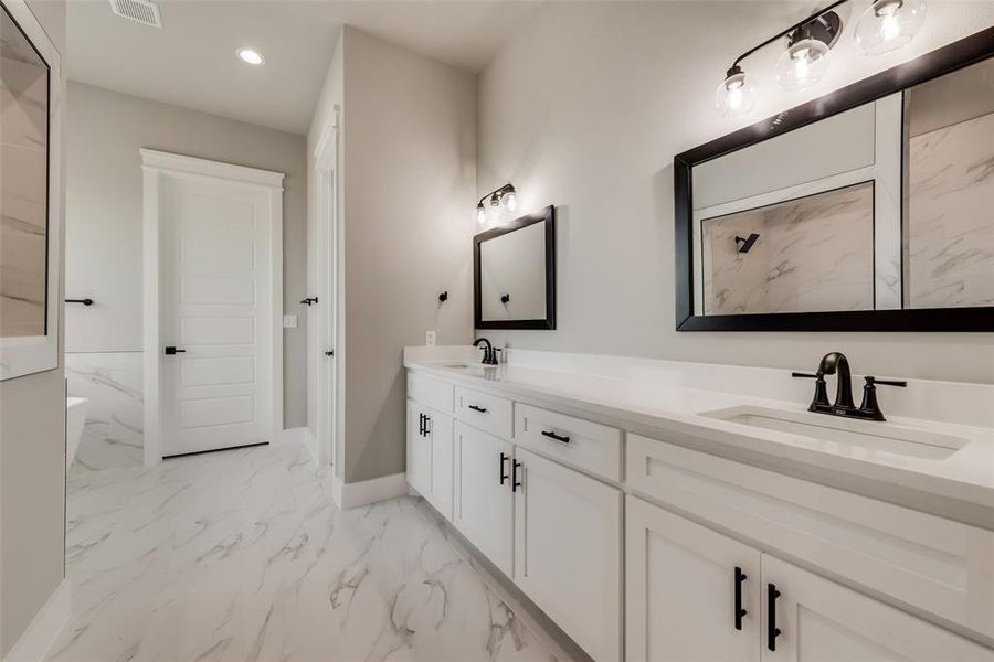 Bathroom with tile patterned floors and vanity