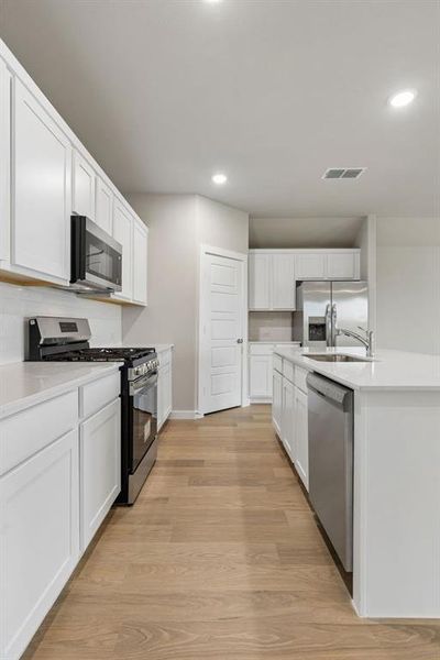Kitchen in the Emmy II home plan by Trophy Signature Homes - REPRESENTATIVE PHOTO