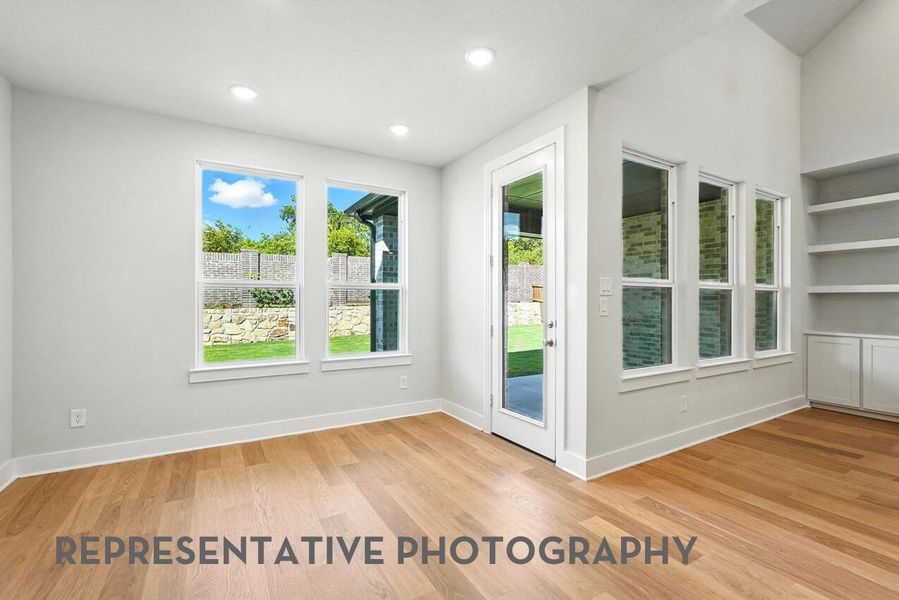 The dining room, bathed in natural light from its windows, offers a warm and inviting space for family and friends to gather.