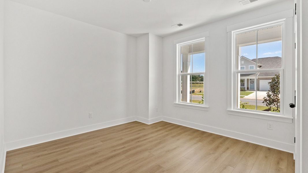 Versatile secondary bedroom with natural light, ideal for family or guests.
