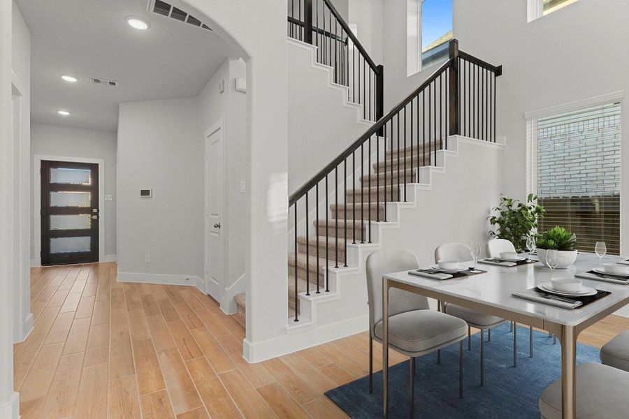 The beautifully designed staircase adds architectural charm and connects the main living space to the upstairs game and media rooms, blending sophistication with comfort. *Staged Photo* The beautifully designed staircase adds architectural charm and connects the main living space to the upstairs game and media rooms, blending sophistication with comfort. *Staged Photo*