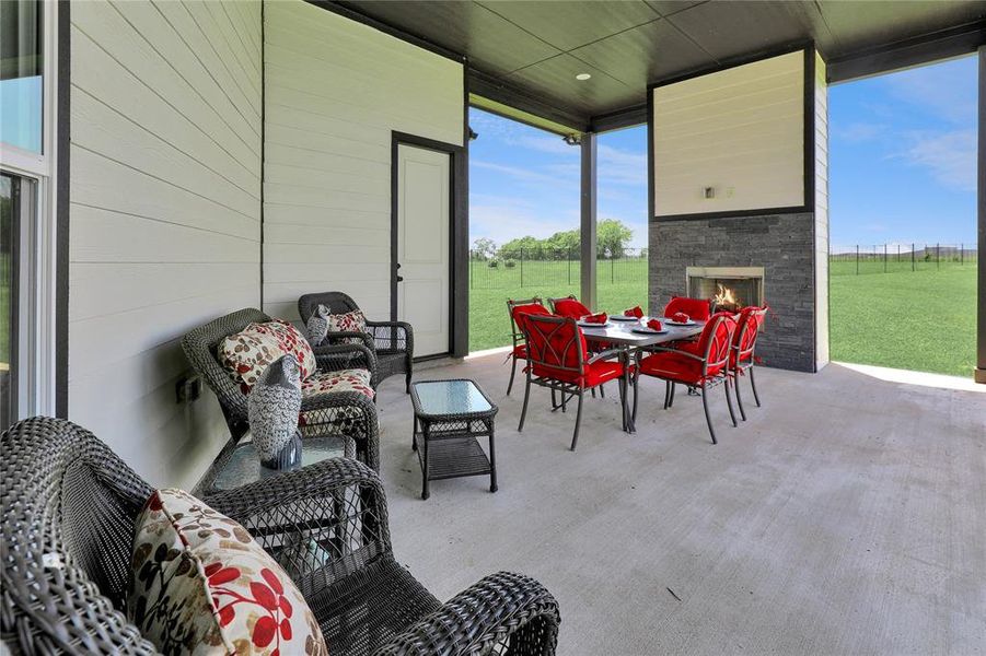 View of patio with outdoor dining space and an outdoor living space with a fireplace View of patio with outdoor dining space and an outdoor living space with a fireplace