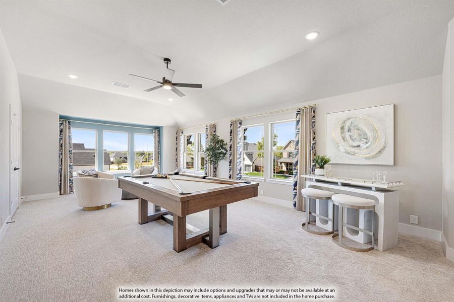 Game room with pool table, vaulted ceiling, ceiling fan, and large windows with natural light