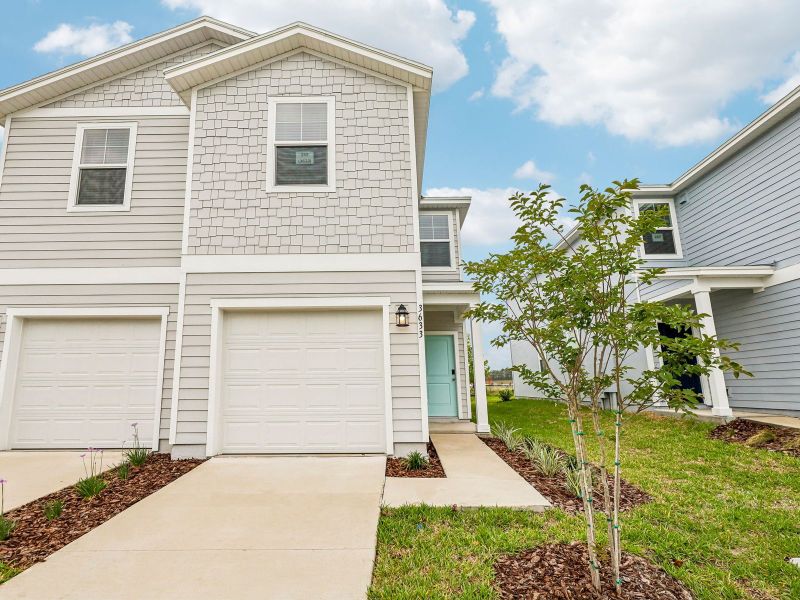 Front exterior of a new home in The District at Oakleaf - The Commons, Middleburg, FL, highlighting curb appeal (Image 1). Front exterior of a new home in The District at Oakleaf - The Commons, Middleburg, FL, highlighting curb appeal (Image 1).