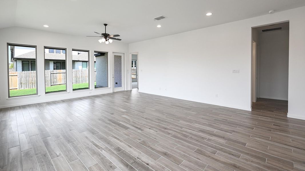 Unfurnished living room featuring recessed lighting, light wood finished floors, and ceiling fan Unfurnished living room featuring recessed lighting, light wood finished floors, and ceiling fan