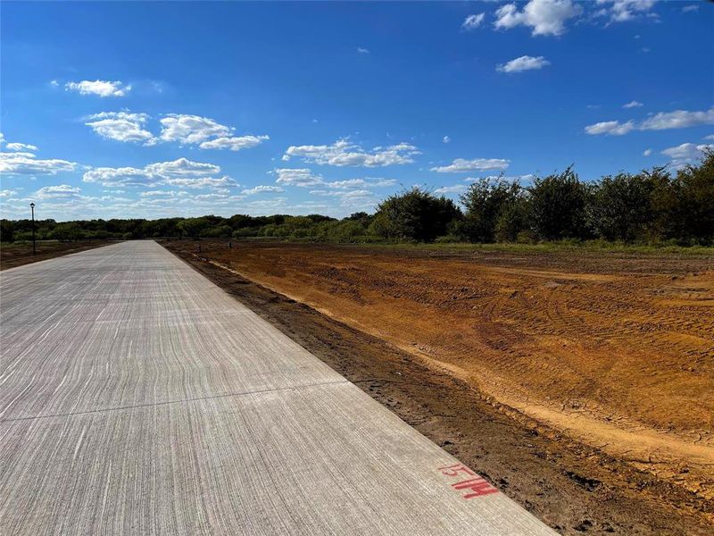 Concrete road. Image was taken before homes broke ground in this community. Concrete road. Image was taken before homes broke ground in this community.