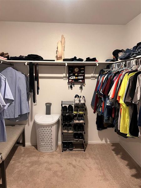 Walk in closet featuring light colored carpet Walk in closet featuring light colored carpet