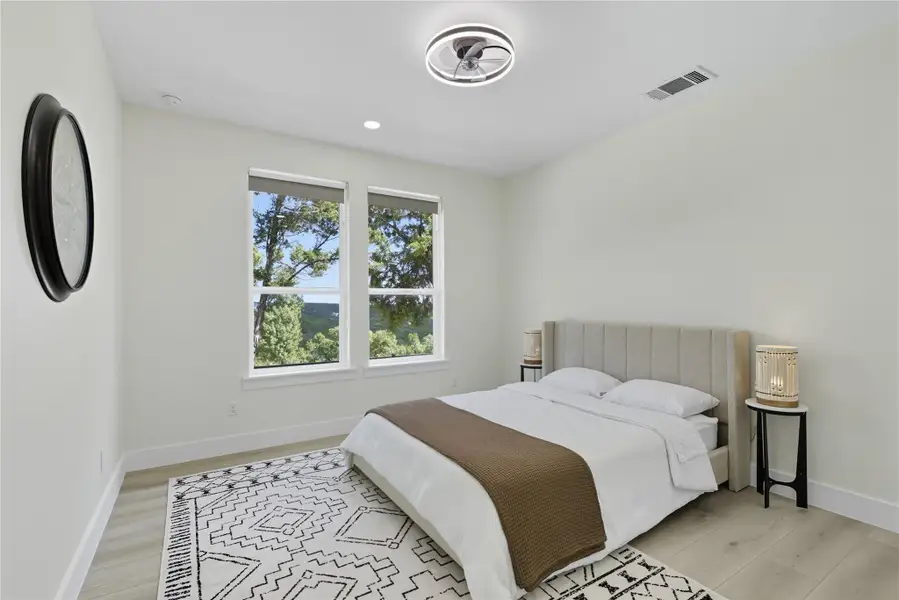Bedroom with light wood-type flooring and recessed lighting