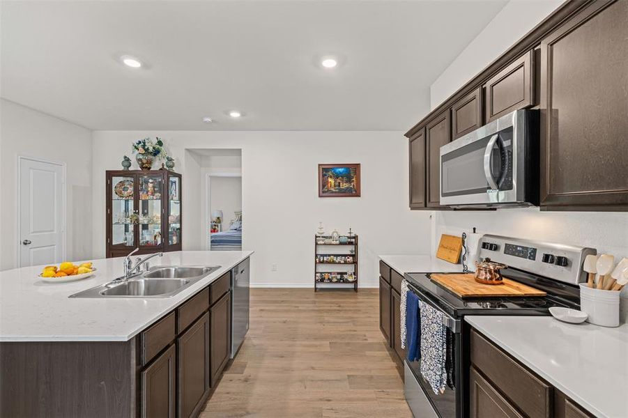 Open concept kitchen with large center island, quartz countertops, stainless steel appliances, and abundant cabinet space. Open concept kitchen with large center island, quartz countertops, stainless steel appliances, and abundant cabinet space.