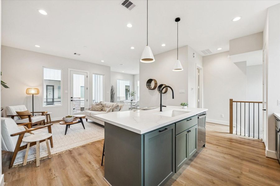 From the kitchen, you can overlook the living room, making it easy to stay connected with friends and loved ones while you cook.