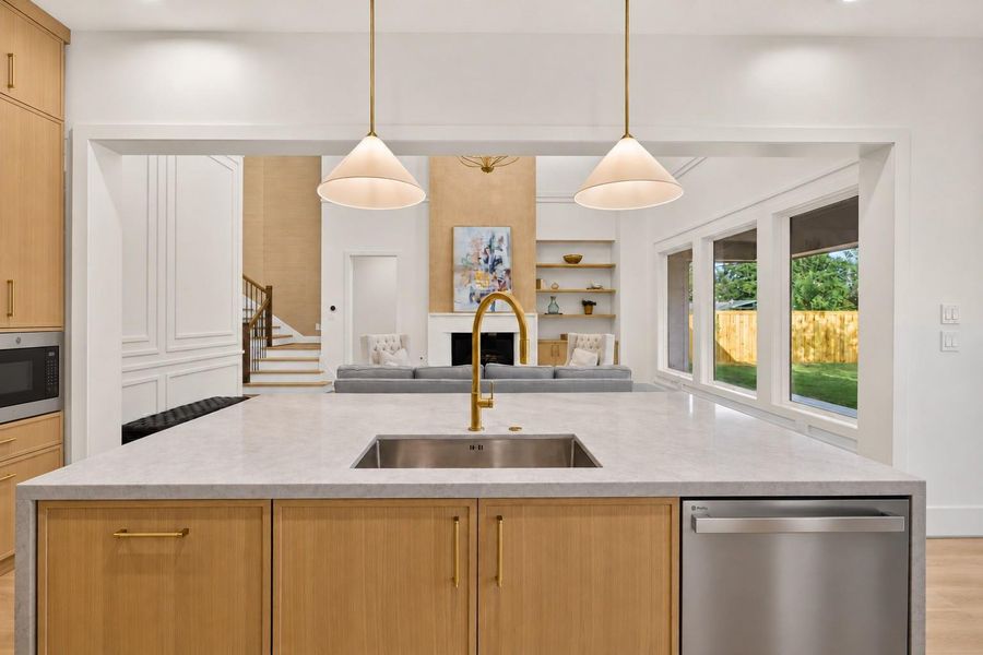 The expansive Taj Mahal quartzite waterfall island offers generous prep space, seating, and a statement centerpiece for gathering with family and friends. The expansive Taj Mahal quartzite waterfall island offers generous prep space, seating, and a statement centerpiece for gathering with family and friends.