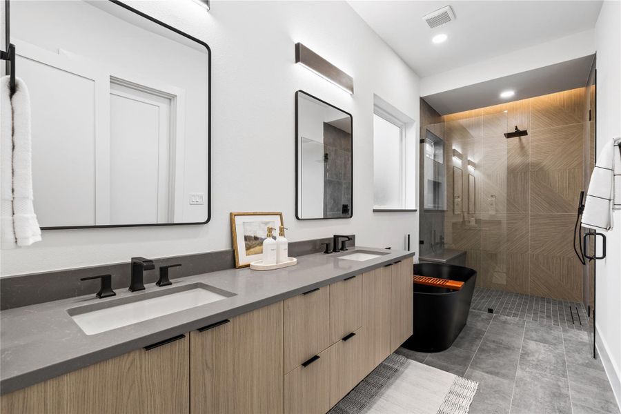 Modern and meditative, the bath layers natural materials with architectural precision. From the floating mirrors to the walk-in shower and freestanding tub, every detail feels intentional, calm, and distinctly refined.