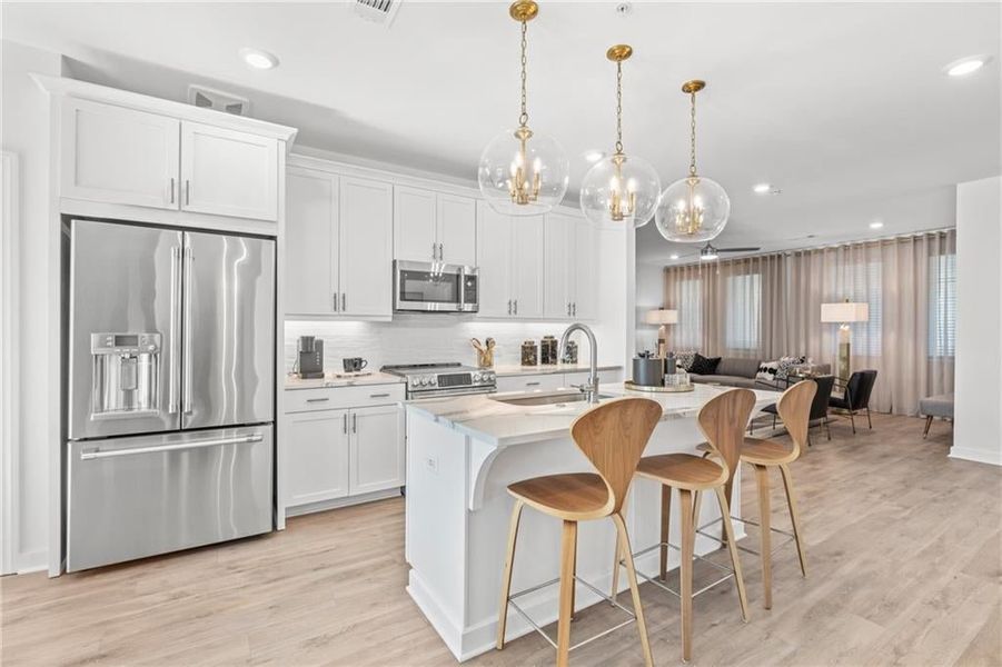 Kitchen opens to the family room.*Images from the model home. Not subject unit*