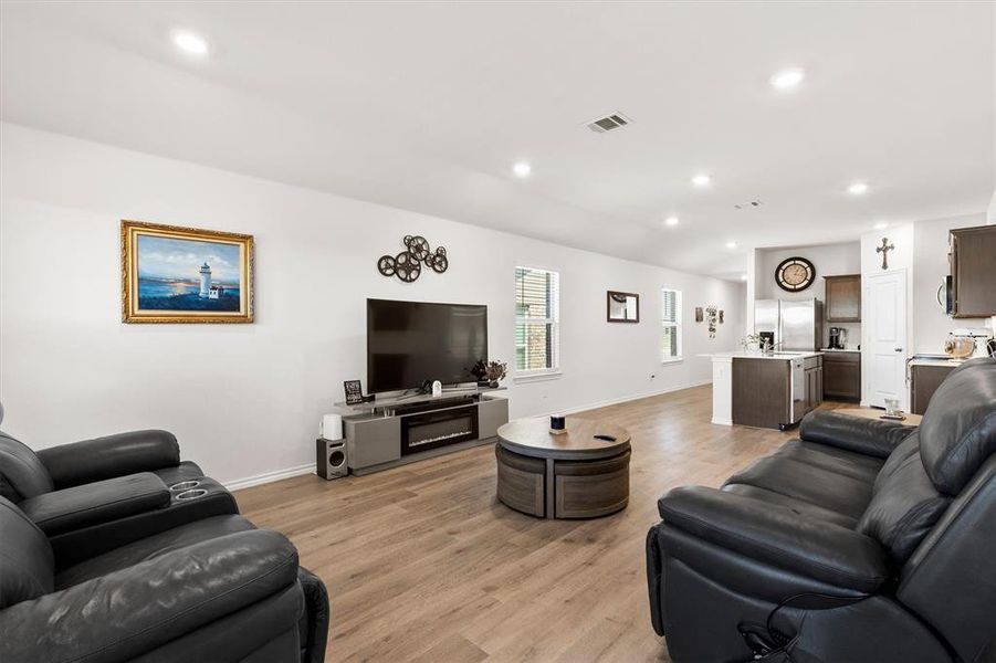 Living area with light wood finished floors and recessed lighting Living area with light wood finished floors and recessed lighting