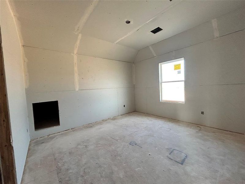 One of the three upstairs bedrooms is empty, featuring simple walls and large windows that fill the room with natural light, ready to be personalized into a cozy retreat.