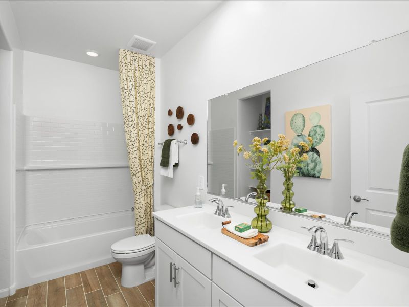 Enjoy dual sinks and built in storage in the second bathroom.