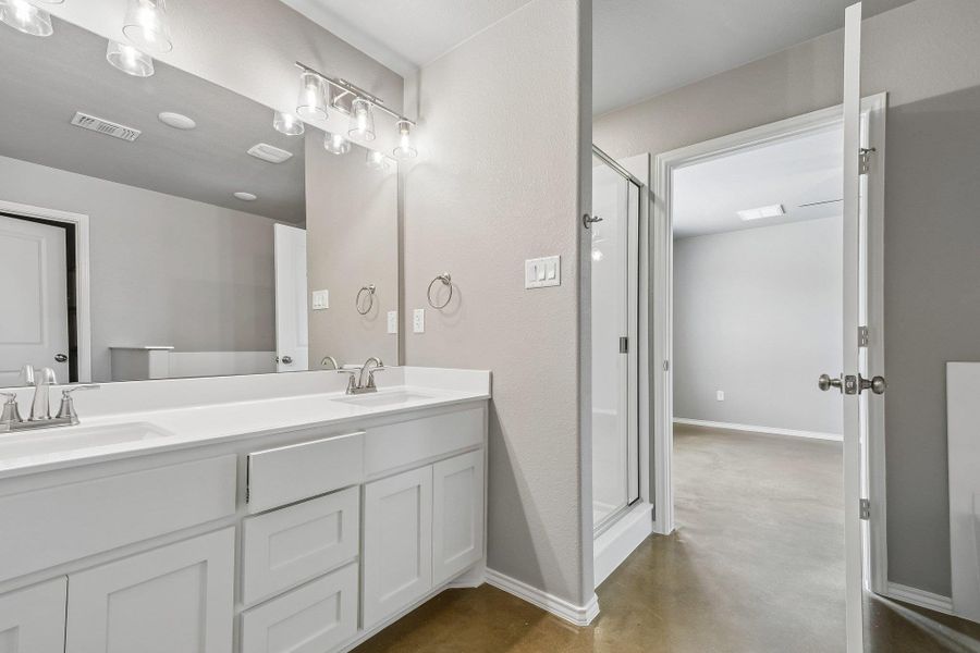 Double vanity sinks and a spacious walk-in shower highlight this well-appointed bathroom. Double vanity sinks and a spacious walk-in shower highlight this well-appointed bathroom.