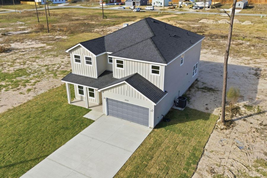Front exterior of a new home in , Conroe, TX, highlighting curb appeal (Image 24).