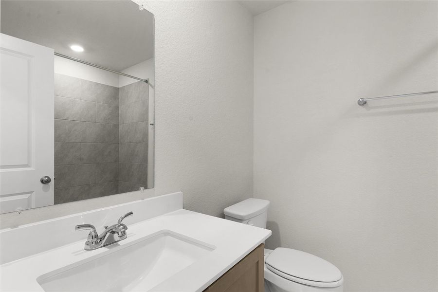 Walk in closet with light carpet and light tile patterned floors