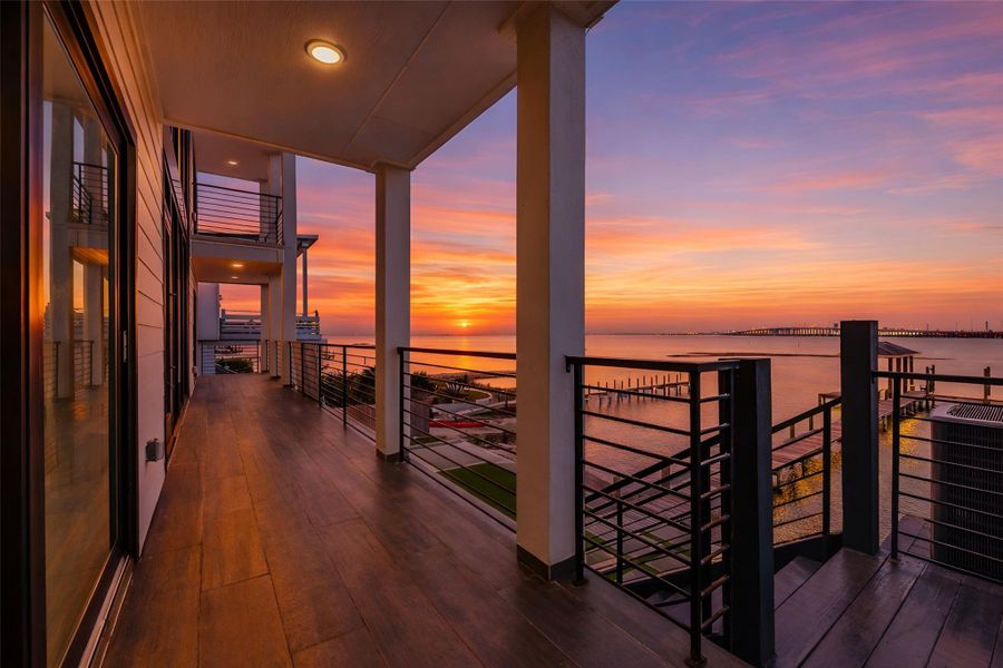 Golden hour comes with a front row seat on the covered waterfront balcony. Open bay views turn each sunset into a private evening experience. You can create an inviting lounge where memorable conversations continue long after the sun goes down. Golden hour comes with a front row seat on the covered waterfront balcony. Open bay views turn each sunset into a private evening experience. You can create an inviting lounge where memorable conversations continue long after the sun goes down.
